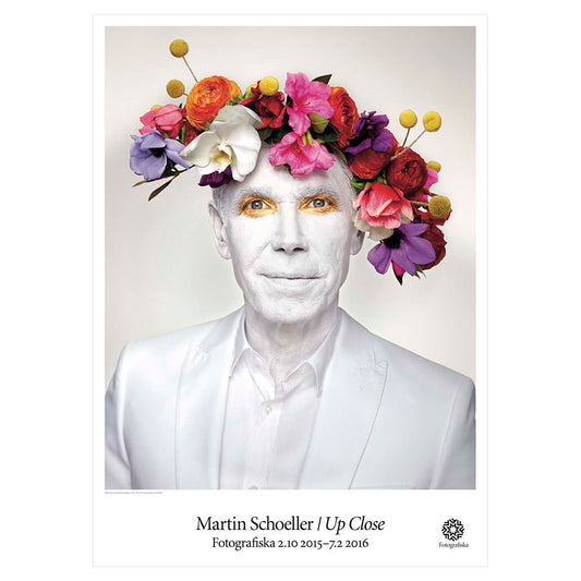 White image of Jeff Koons with colorful floral headpiece. Exhibition title below: Martin Schoeller | Up Close