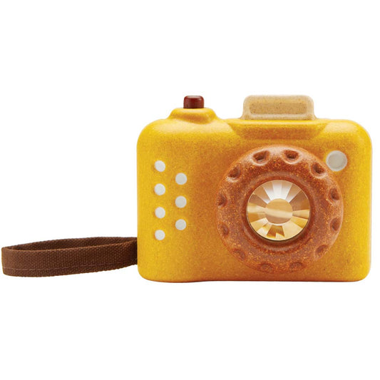 Toy yellow camera with lenses and a strap