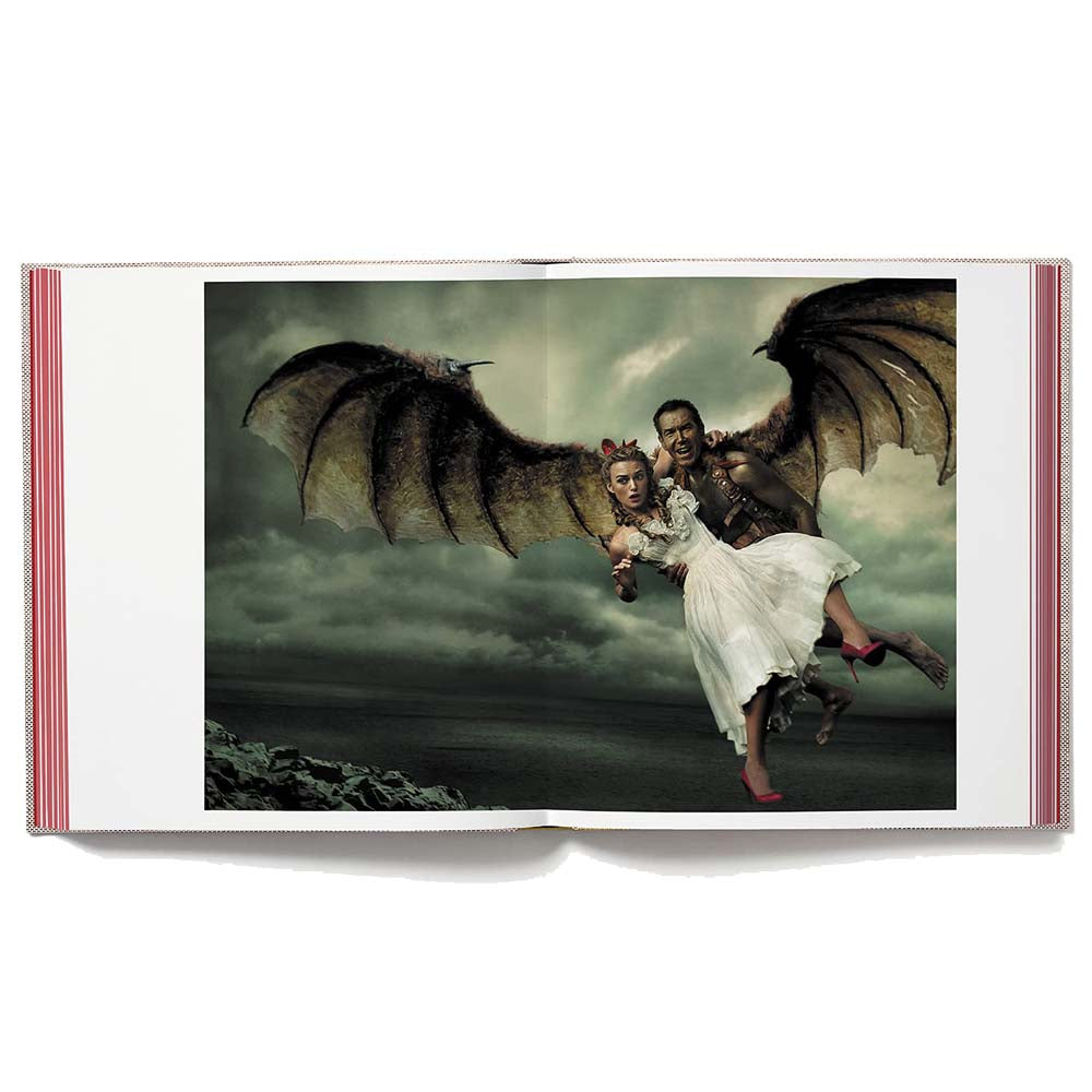 Open book shot of Wonderland, showing full-width image of man with wings holding a woman