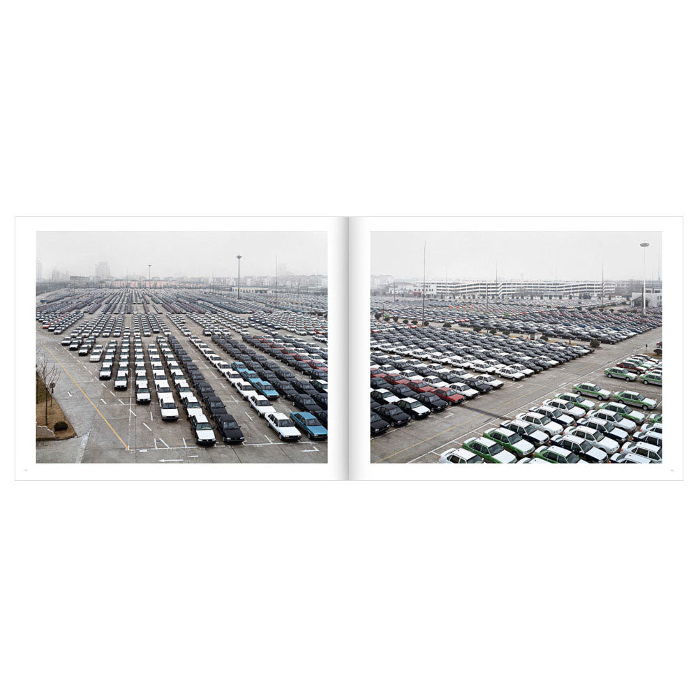 Open spread of Edward Burtynsky: Oil, showing two color photos of parking lots with many many cars
