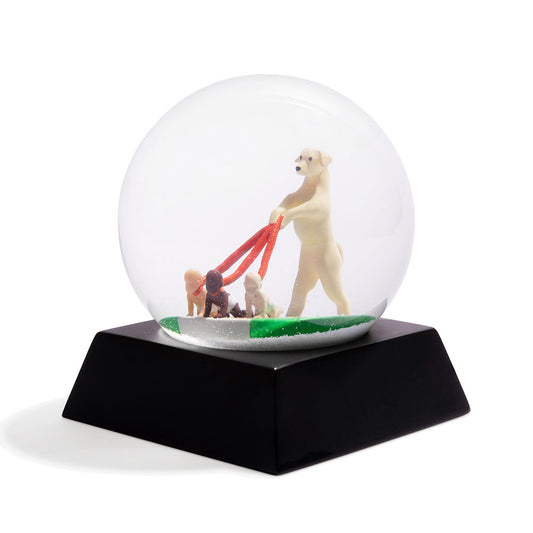 Dog Walker snow globe, showing a dog walking human babies