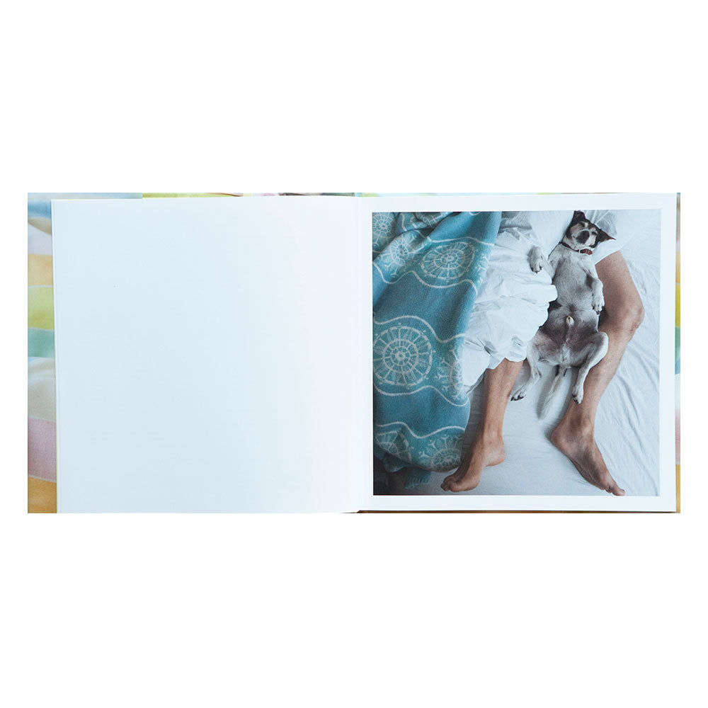 Lisa Strömbeck: In Bed (Signed), open book shot, showing a color photo of a person lying in bed with a dog