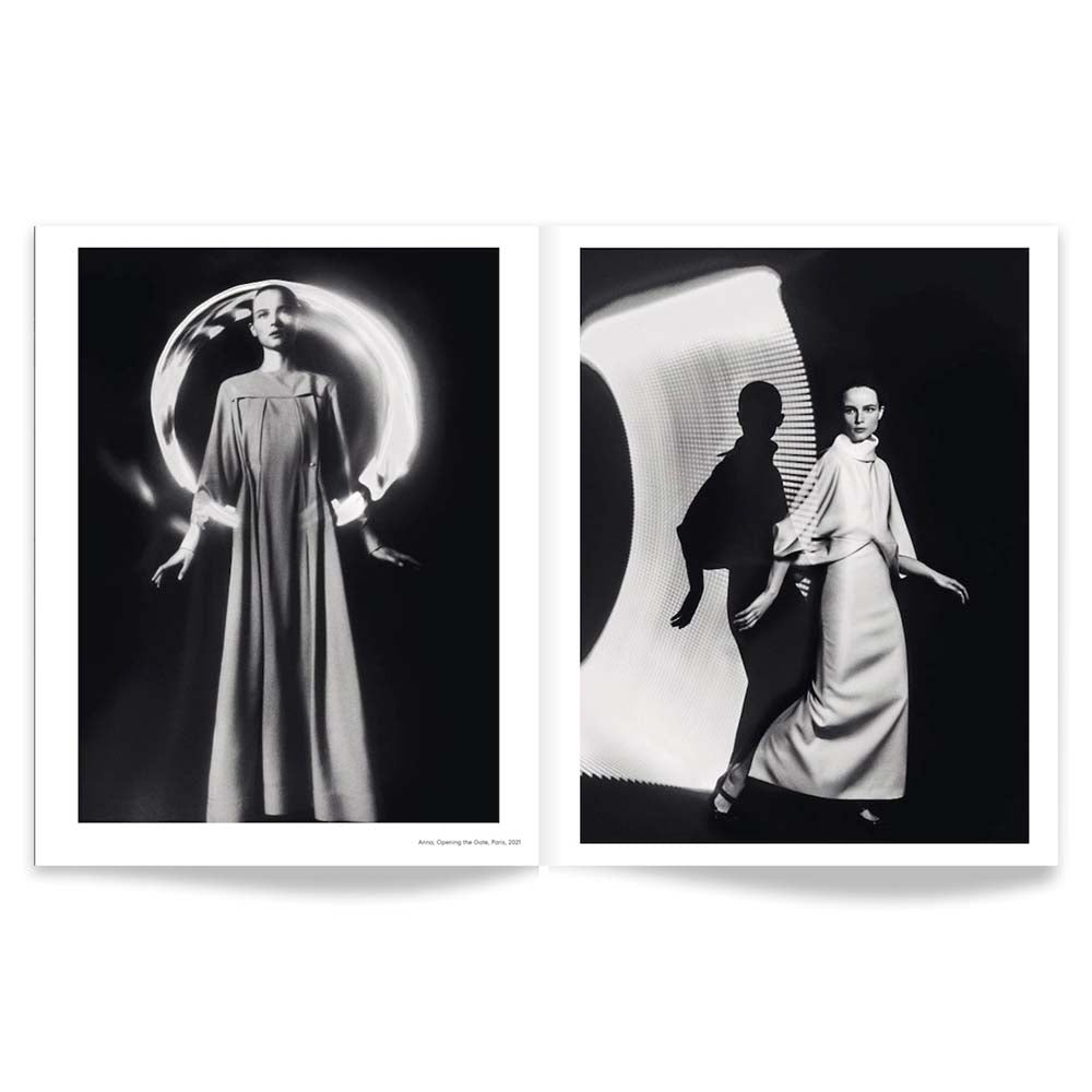Open book shot of Elizaveta Porodina - Un/Masked, featuring two black and white images of fashion models in spacey setting