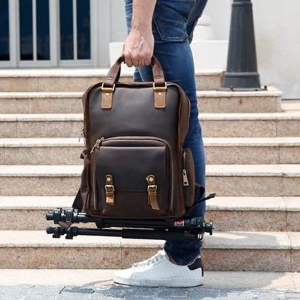 Gaetano Leather Camera Bag with Tripod Holder, being carried by the hand