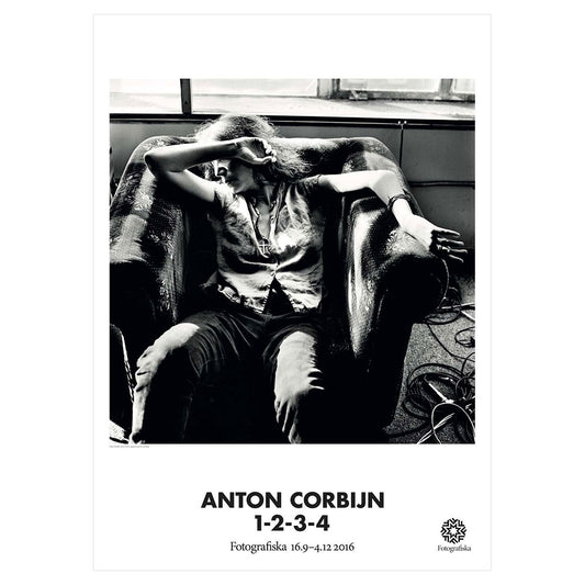 Black and white image of Patti Smith in a chair looking at her right arm. Exhibition title below: Anton Corbijn | 1-2-3-4