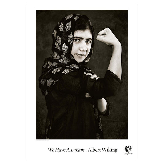 Black and white image of Malala Yousafzai making defiant expression toward the camera. Exhibition title below: We Have a Dream | Albert Wiking