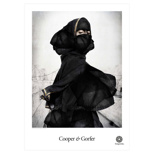 Woman with body covered in black except for eyes, looking to the right. Artist name below: Cooper & Gorfer