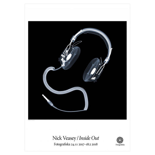 Inverted exposure of a pair of headphones, which glowing white.  Exhibition title below: Nick Veasey | Inside Out