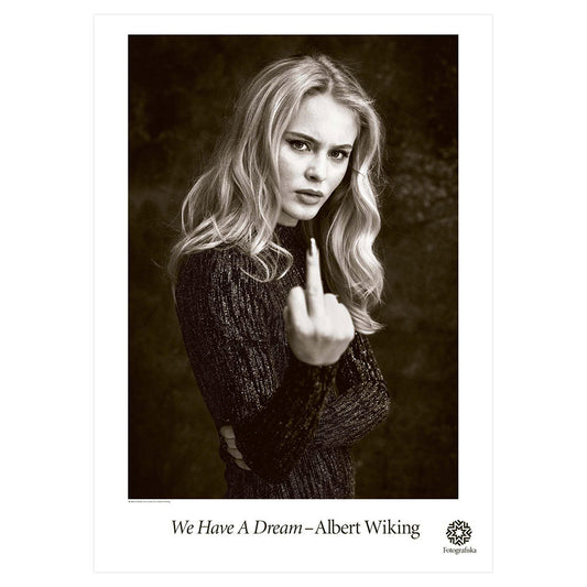 Black and white portrait of Zara Larson extending middle finger to the camera with defiant look on her face. Exhibition title below: We Have a Dream | Albert Wiking