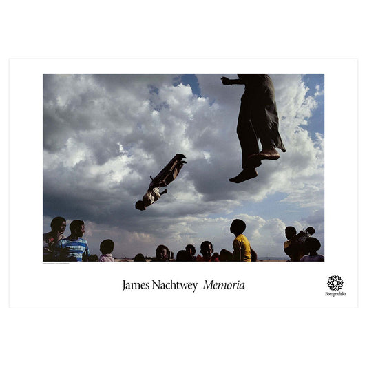 Colorful scene of kids jumping on trampolines with other kids watching. Exhibition title below: James Nachtwey | Memoria