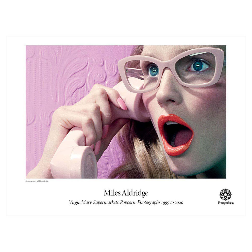 Colorful closeu of woman with pink glasses and lipstick on the phone with a shocked expression on her face. Exhibition title below: Miles Aldridge | Virgin Mary, Supermarkets, Popcorn, Photographs 1999 to 2020
