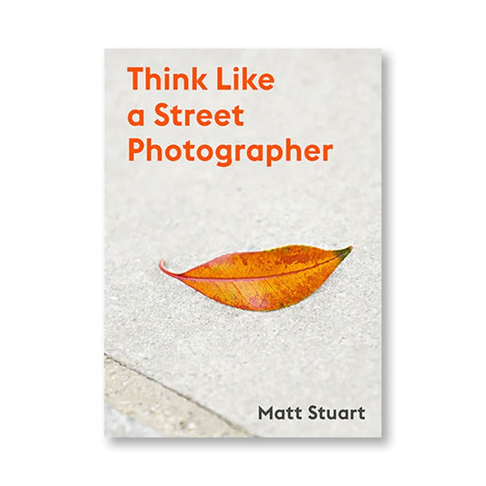 Cover of "Think Like a Street Photographer" by Matt Stuart, showing a zoom color photo of a leaf on a sidewalk