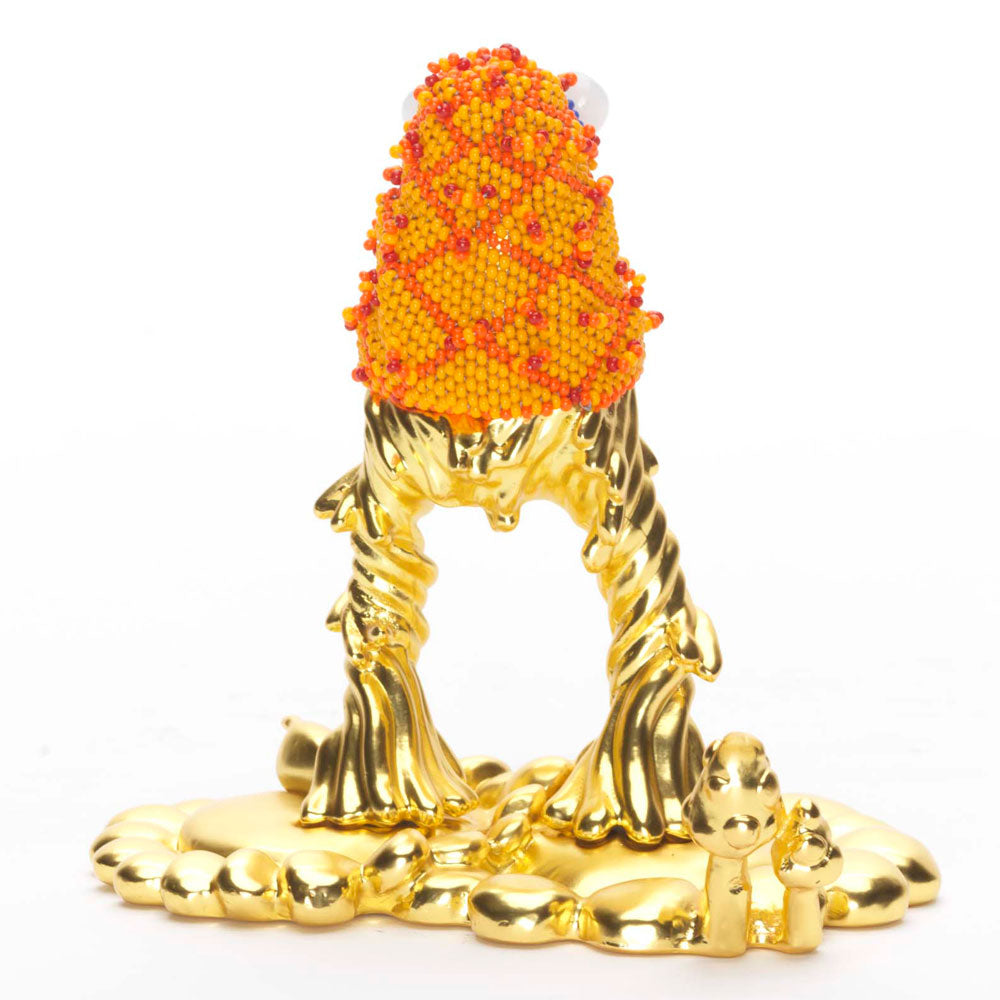 Back of quirky orange and gold statue of a monster with bugging eyes and tongue sticking out