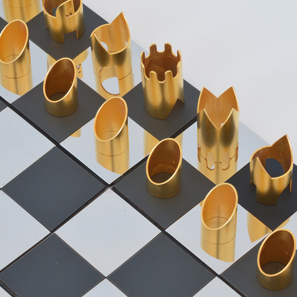 Gold and silver chess pieces on chessboard