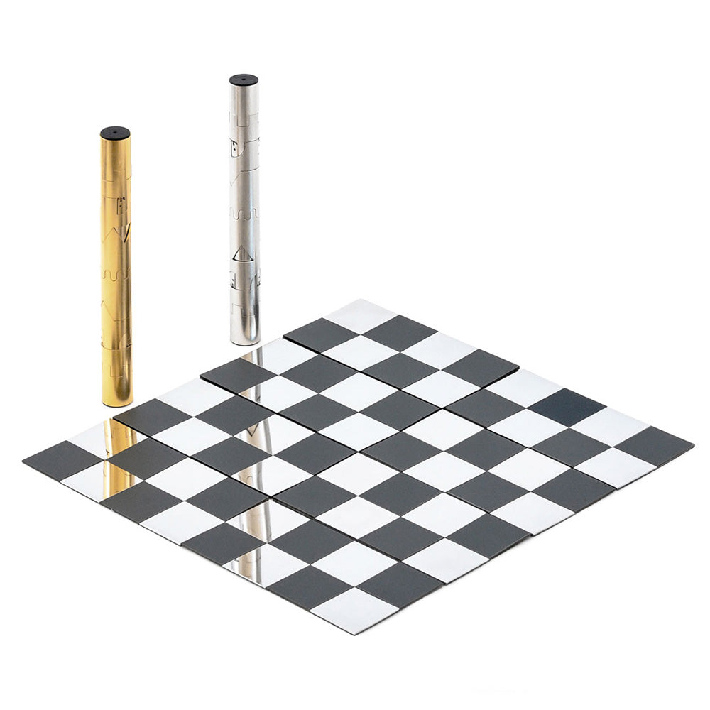 Gold and silver chess pieces stacked next to a chessboard