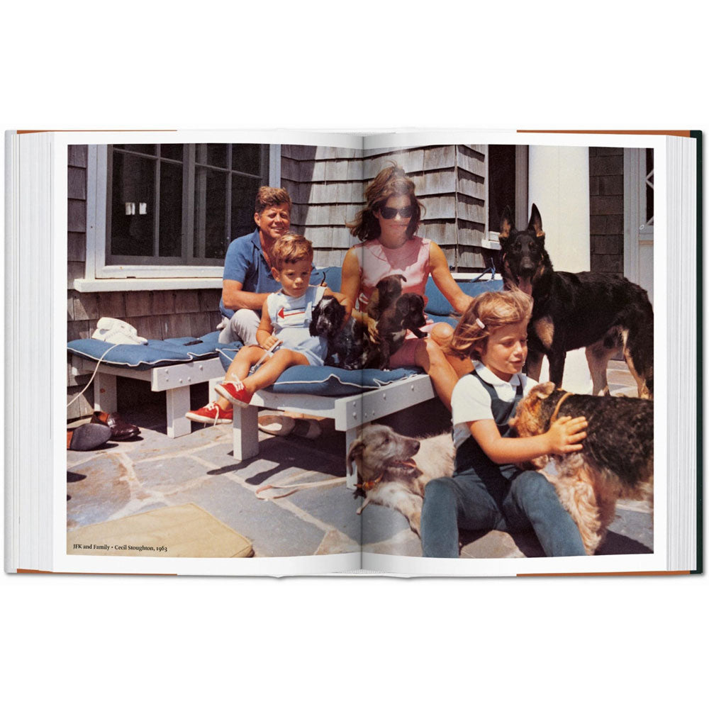 Spread shoot of Dog in Photography book, showing a full-width color photo of John F. Kennedy's family playing with dogs