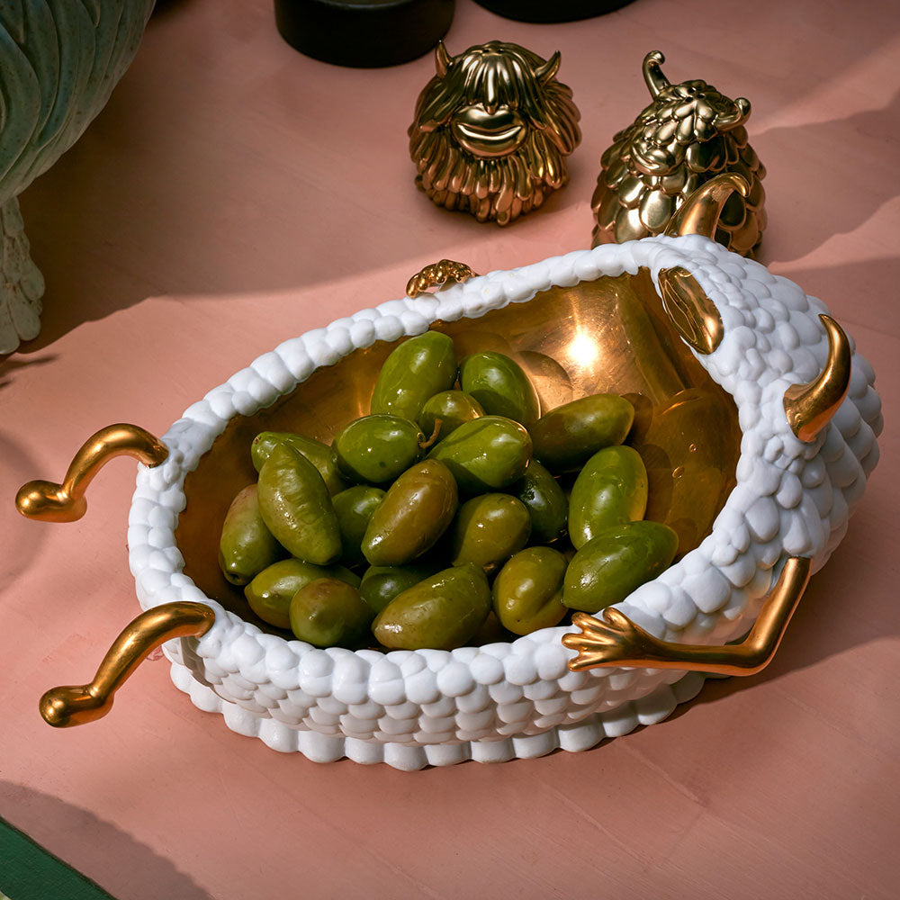Catch-All Monster filled with olives on a table
