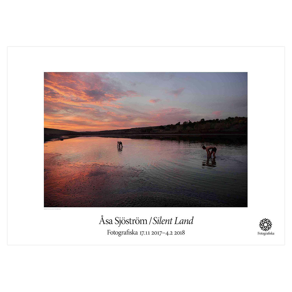 Beautiful sunset over a forest and water landscape. Exhibition title below: Asa Sjostrom | Silent Land