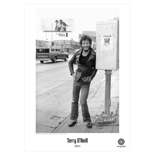 Black and white image of Bruce Springsteen leaning against a payphone.  Exhibition title below: Terry O'Neill | Stars