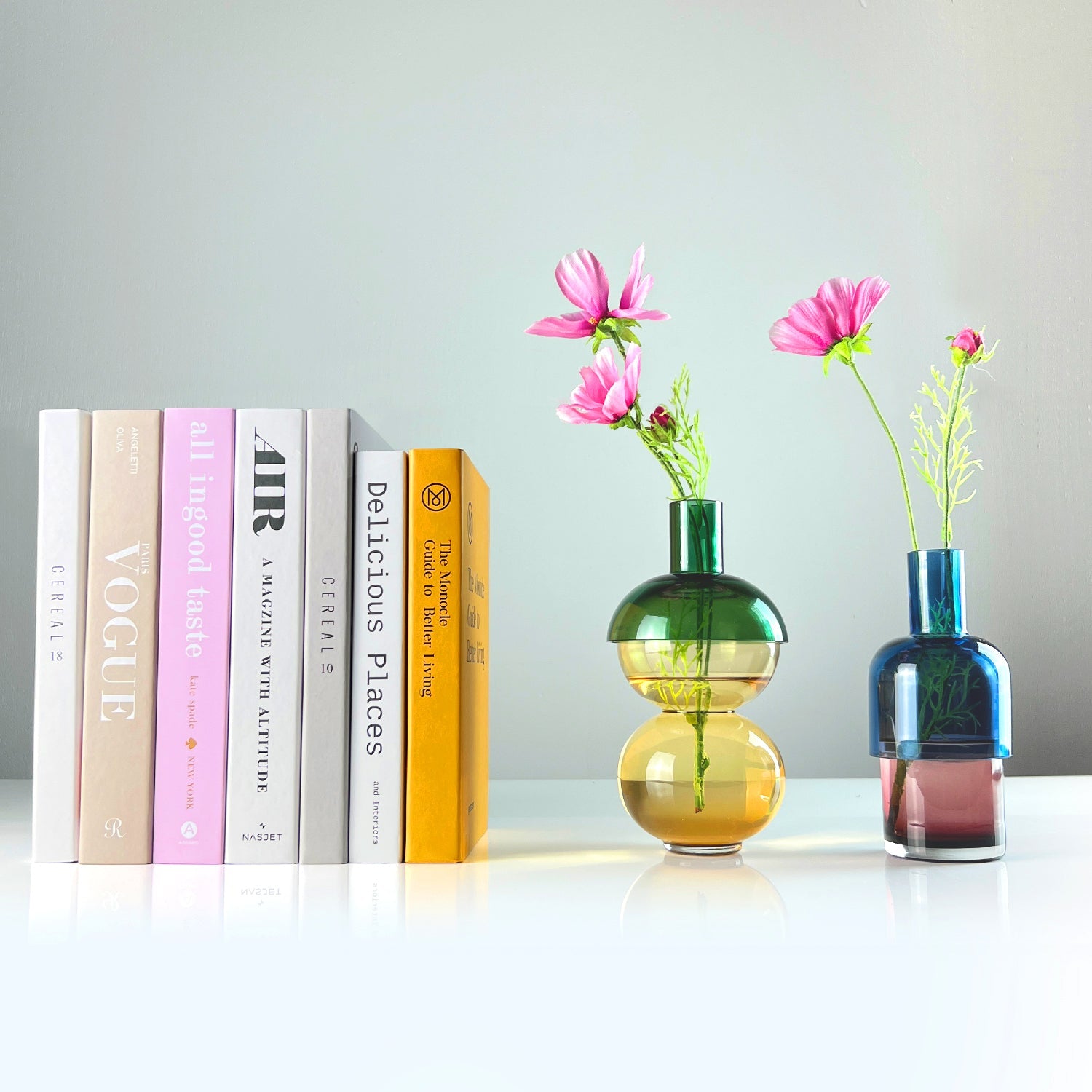 Fusion Lemon Vase Set, Small, shown with flowers next to a stack of books.