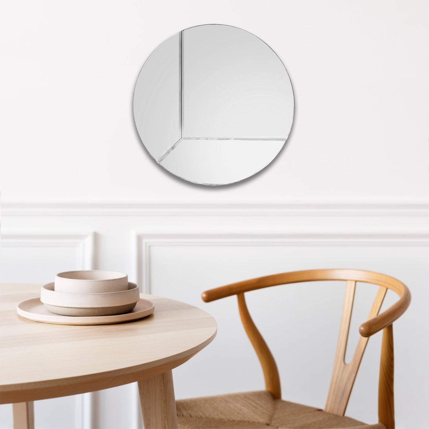 Round Reversible Mirror, XL, shown in a living room next too a coffee table.