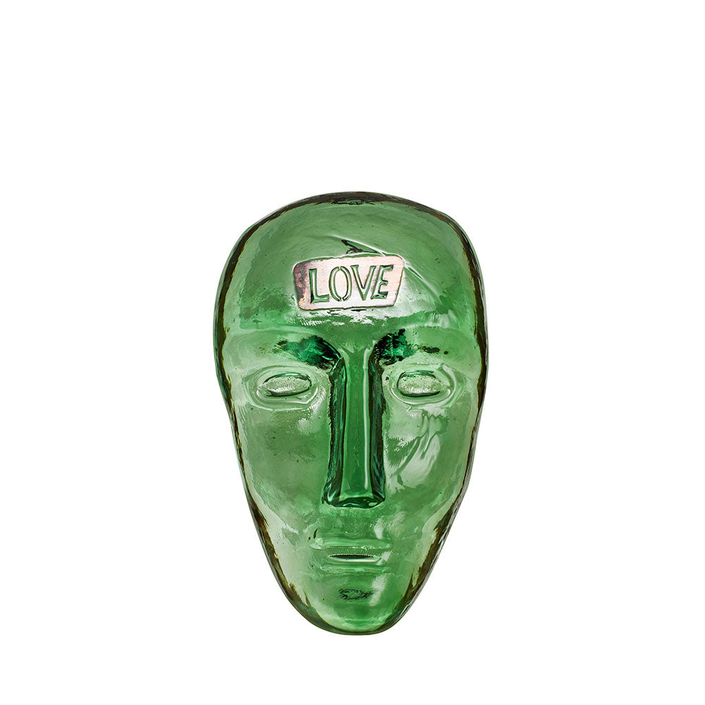 Green glass face with the word "Love" written on the forehead. Designed by Bertil Valien.