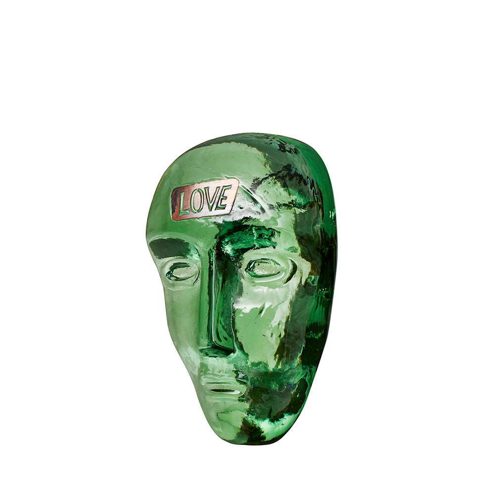 Green glass face with the word "Love" written on the forehead. Designed by Bertil Valien.