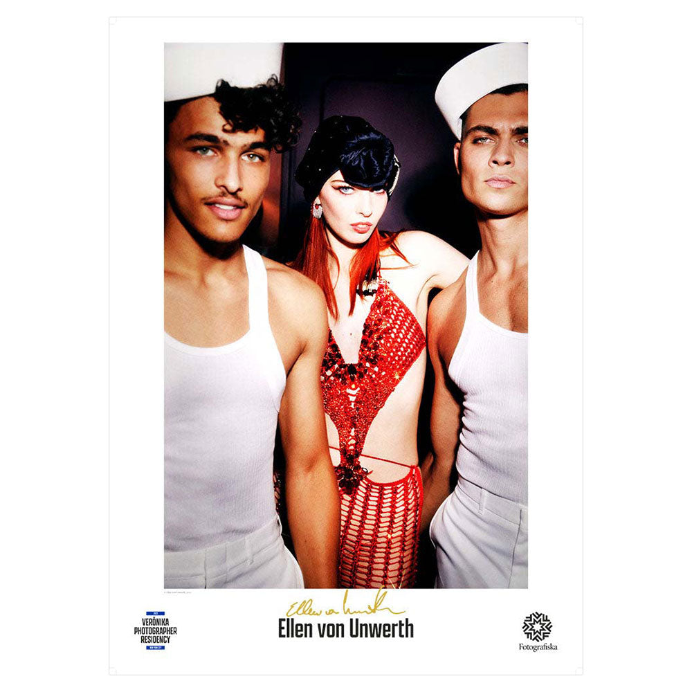 Woman and two sailors, looking at camera. Artist name below and autograph in gold: Ellen von Unwerth