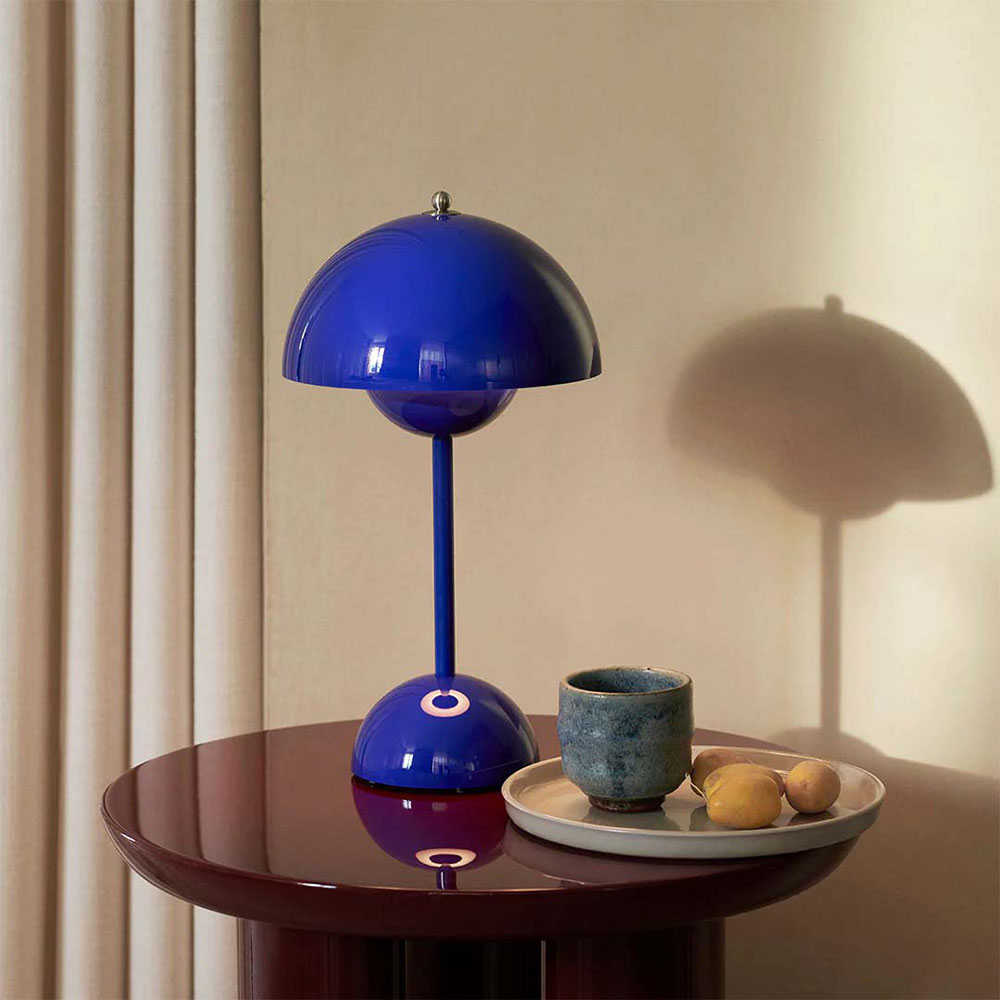 &Tradition Flowerpot Portable Table Lamp VP9, blue, sitting on a kitchen table.