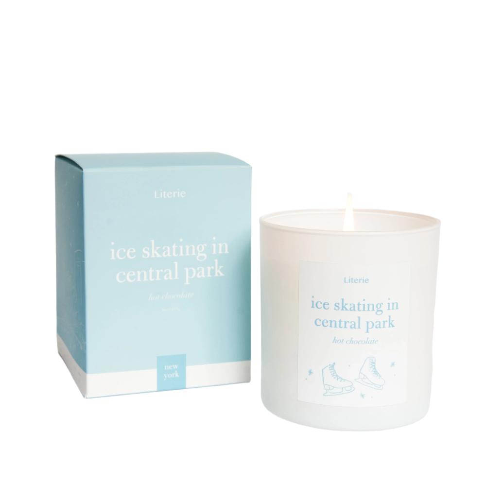 Literie "ice Skating in Central Park" Candle  next to packaging