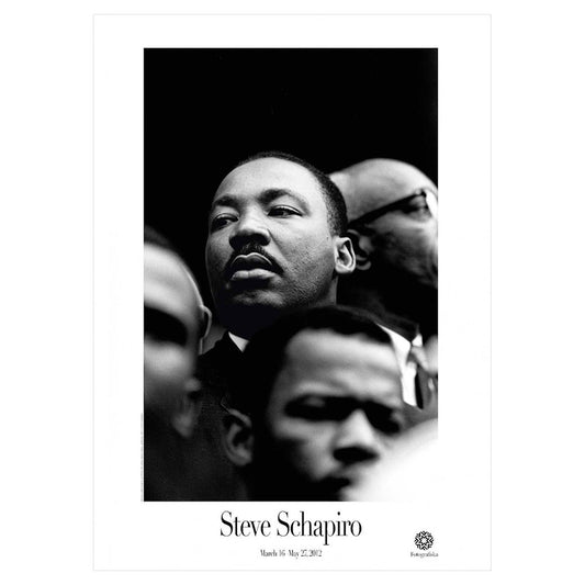 Black and white image of Martin Luther king's face among other people, with a solemn expression. Artist name below: Steve Schapiro