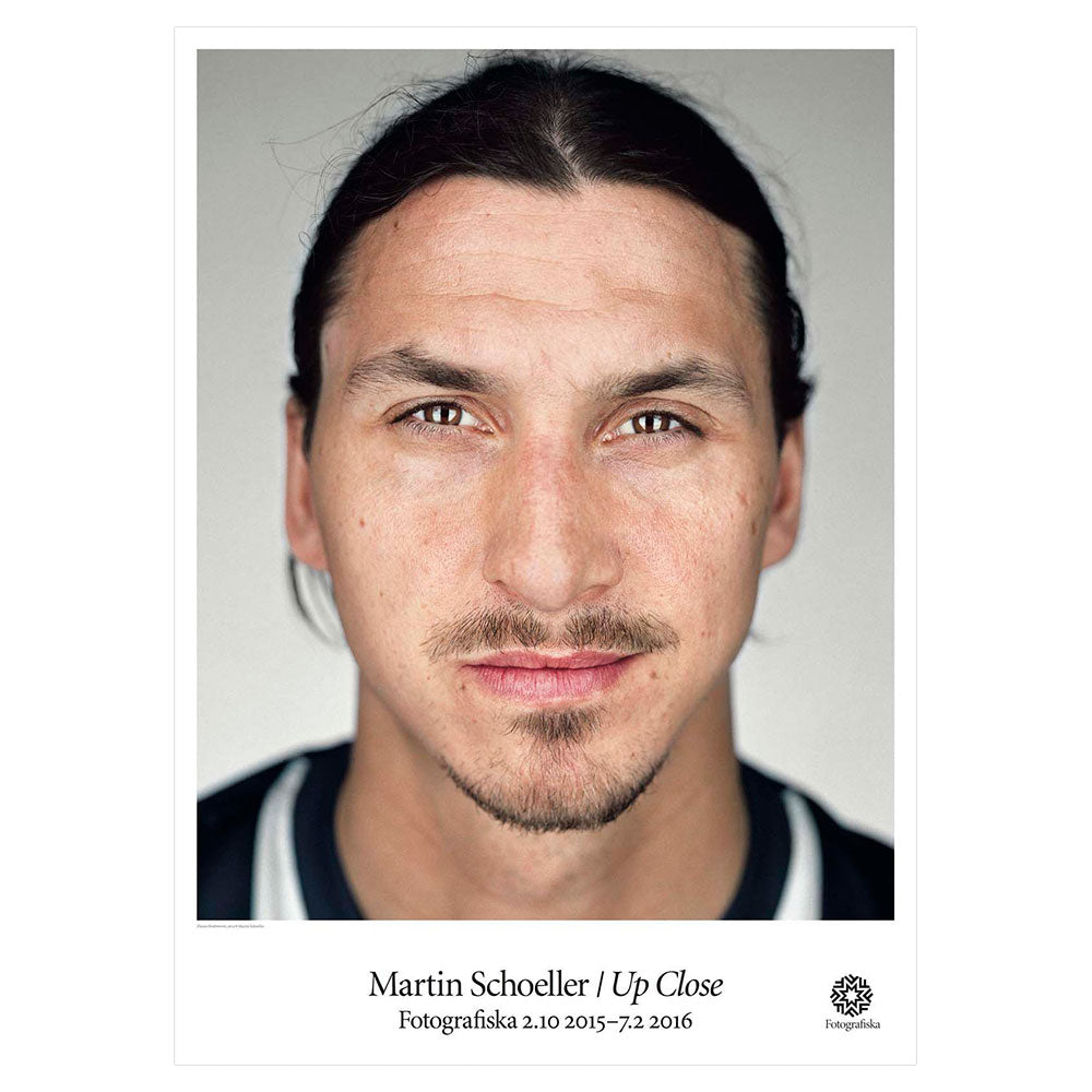 Color portrait of Zlatan Ibrahimovic with a slight smirk on his face. Exhibition title below: Martin Schoeller | Up Close
