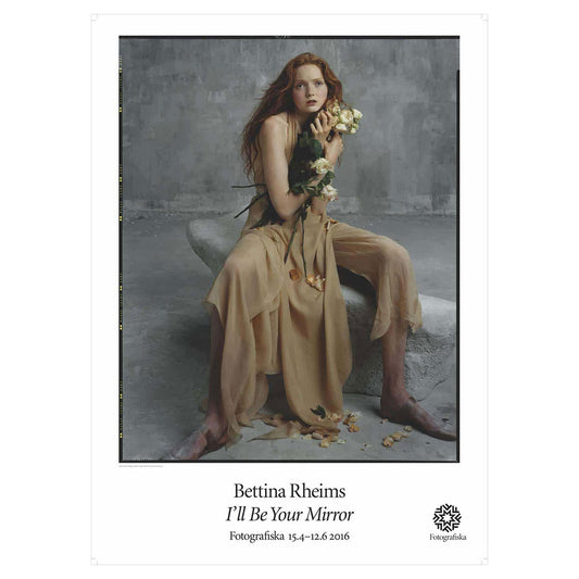 Lily Cole sitting down, holding flowers. Exhibition title below: Bettina Rheims | I'll Be Your Mirror