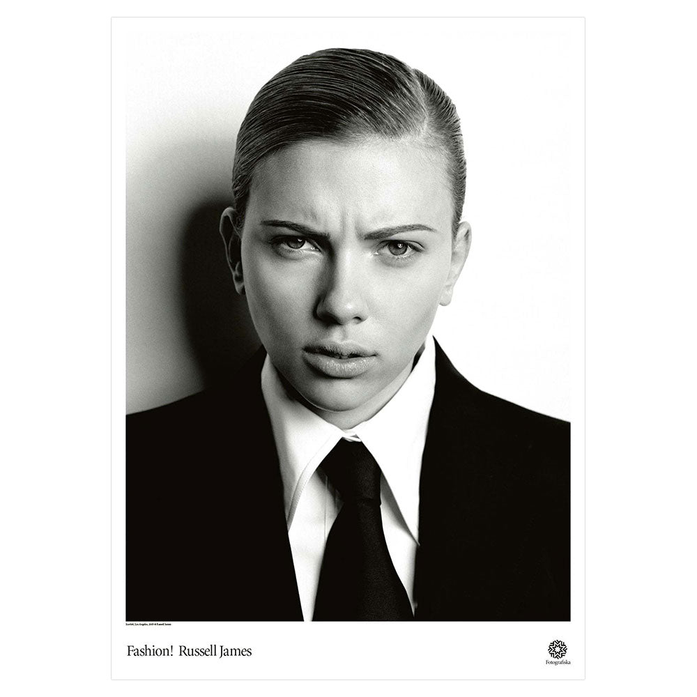 Black and white image of Scarlett Johansson in suit and tie, staring quizzically at viewer. Exhibition title below: Fashion! | Russell James