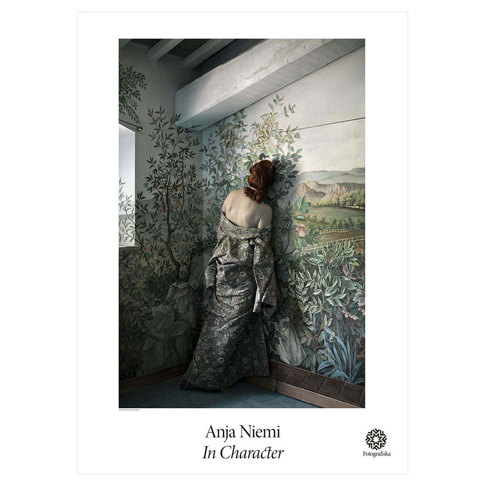 Colorful portrait of woman leaning against wall with landscape drawings on it, blending in with her dress.  Exhibition title below: Anja Niemi | In Character