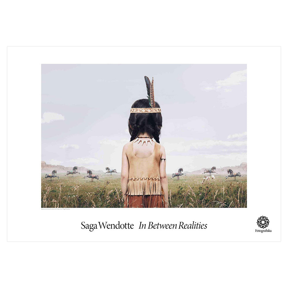 Native American child turned around, facing a group of running horses in a green field. Exhibition title below: Saga Wendotte | In Between Realities