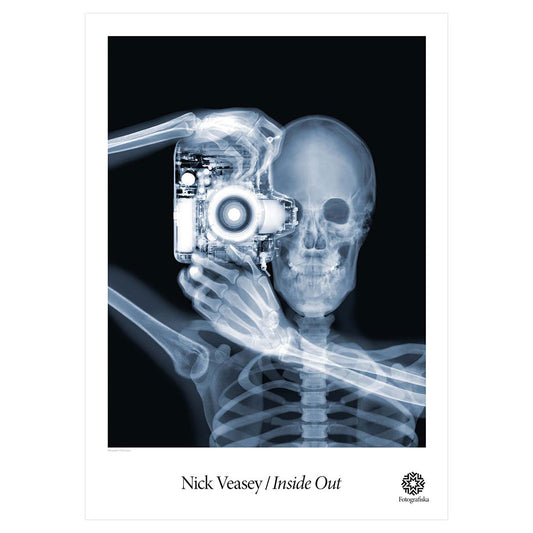 X-Ray of person holding a camera, pointed at the viewer. Exhibition title below: Nick Veasey | Inside Out