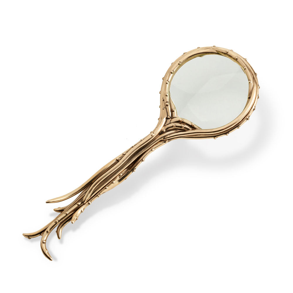 Interestingly designed gold magnifying glass with a base like octopus tentacles