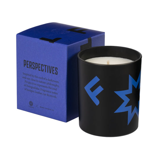 Black candle with purple Fotografiska logo on side. Purple box to the left of the candle with "Perspectives" written in black.