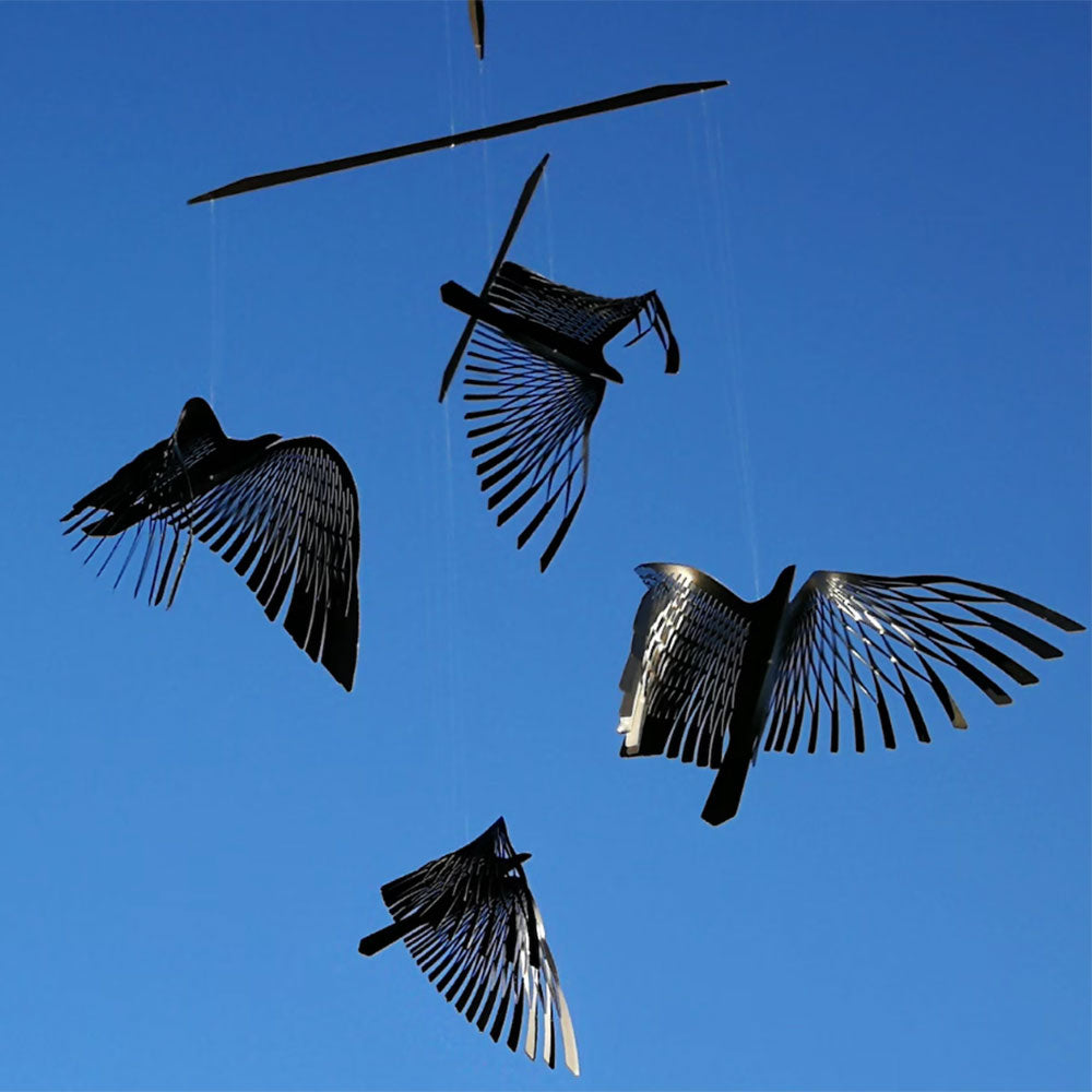 Black birds mobile lifestyle shot against blue sky