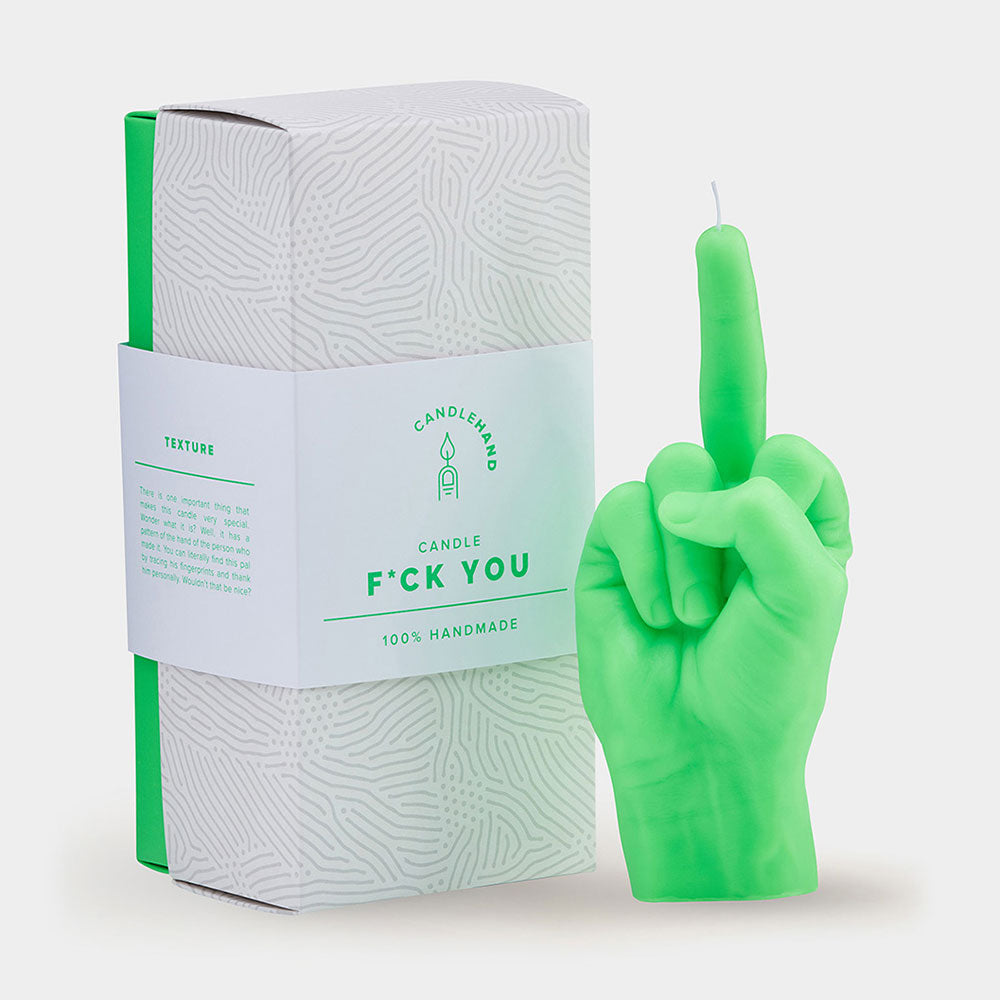 Green middle finger candle beside packaging that says "F*ck you"
