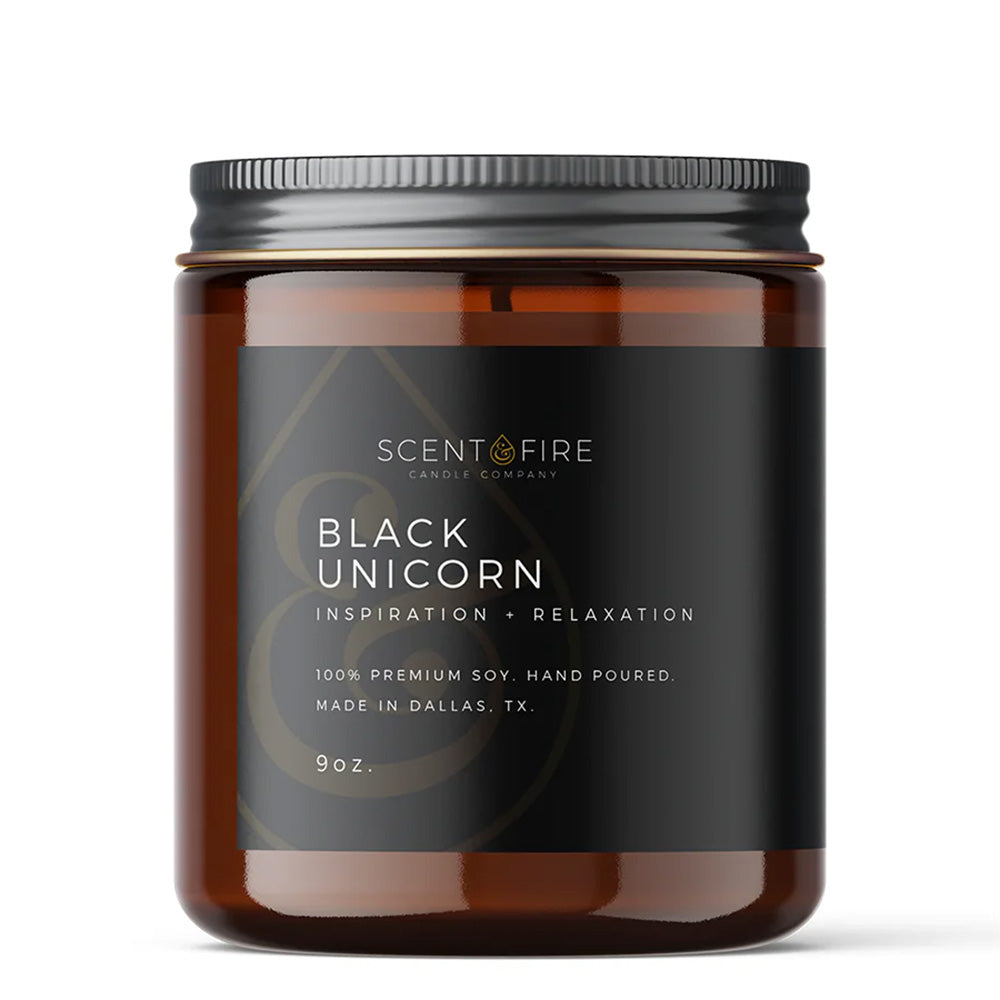Candle jar with Scent & Fire Label, with the name "Black Unicorn" and writing underneath: Inspiration, Relaxation, 100% Premium Soy, Hand-poured, Made in Dallas, TX, 9 ounces